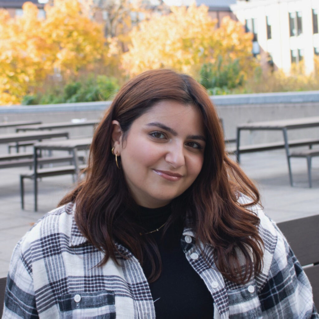 A photo of Chrystel Abi Samra outside in a plaid shirt.