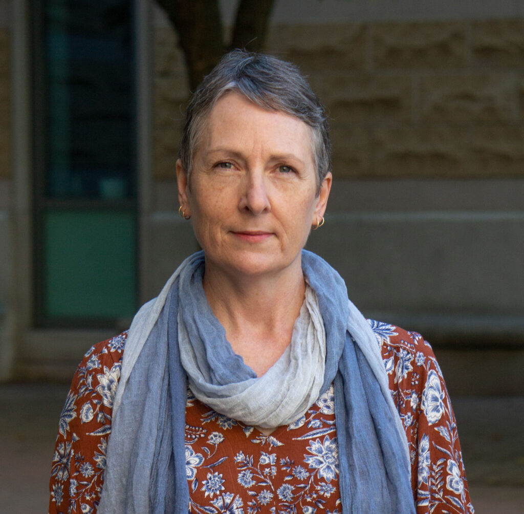 A photo of Nicole Blanchett wearing a blue scarf.